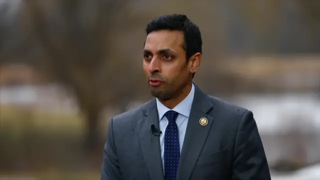 Democratic Congressman Suhas Subramanyam in a grey suit and blue tie.
