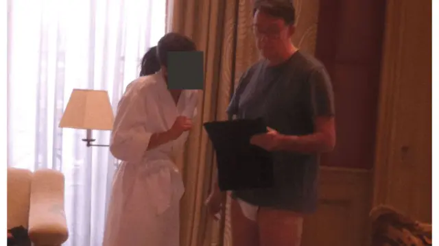 An image of Peter Mandelson in a t-shirt and his underwear published as part of the latest Epstein file drop - a female whose face is redacted is standing next to him