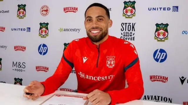Zak Vyner signing his contract at Wrexham