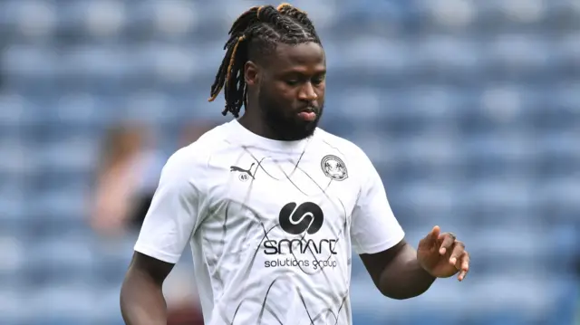 Jacob Mendy warming-up for Peterborough