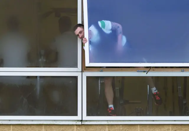Scott Brown peaks out a window