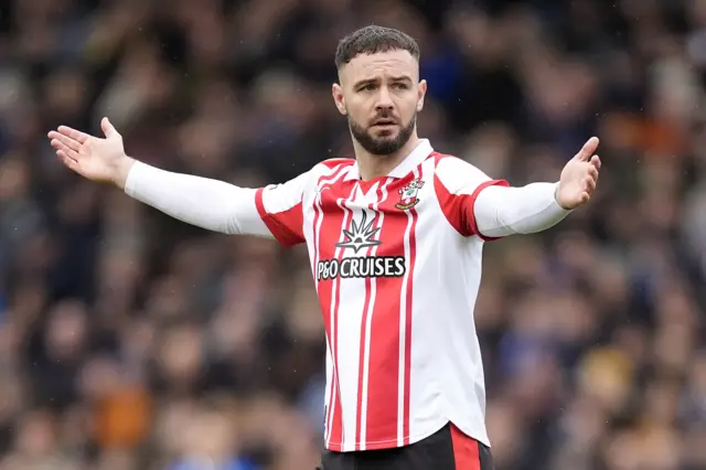 Southampton striker Adam Armstrong with his arms out by his side