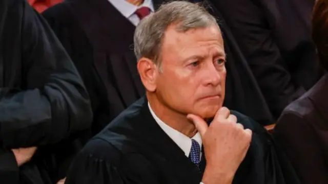 close-up of Justice John Roberts with his hand on his chin