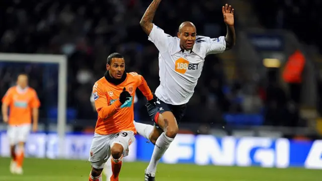 Zat Knight of Bolton and DJ Campbell of Blackpool battle for the ball during the Barclays Premier League match between Bolton Wanderers and Blackpool in 2010