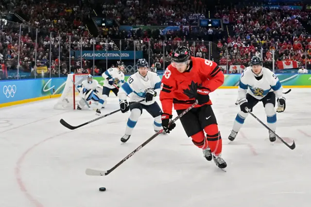 Mitch Marner (C) controls the puck