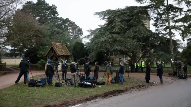 Media teams gather outside Sandringham with cameras and equipment