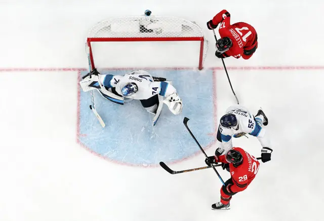 uuse Saros #74 and Rasmus Ristolainen #55 of Team Finland defend the net against Team Canada in the third period during the Men's Semifinals Playoff match between Canada and Finland on day fourteen of the Milano Cortina 2026 Winter Olympic games at Milano Santagiulia Ice Hockey Arena