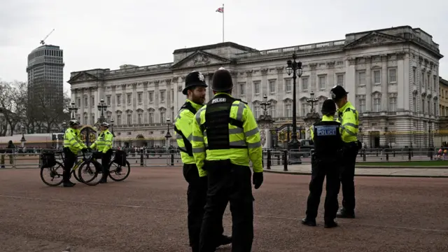 Police stand outside Buckingham Palace