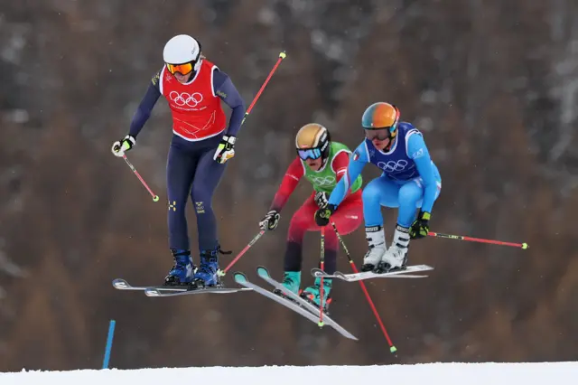 Sandra Naeslund of Team Sweden leads Katrin Ofner of Team Austria and Jole Galli of Team Italy in the Women's Ski Cross Quarterfinals on day fourteen of the Milano Cortina 2026 Winter Olympic games at Livigno Snow Park