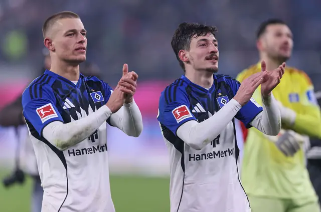 Miro Muheim and Giorgi Gocholeishvili of Hamburg celebrate the draw with the fans during the Bundesliga match between Hamburger SV and FC Bayern München