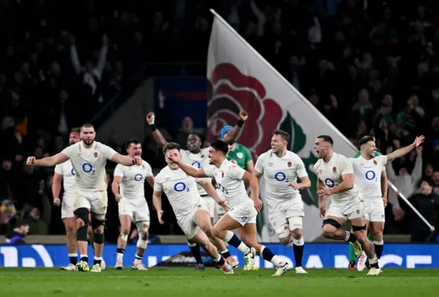 Marcus Smith leads England's celebrations after kicking the winning drop-goal against Ireland in 2024
