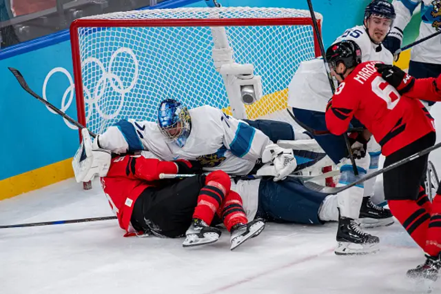 Sam Bennett of Canada clashes with Goalie Juuse Saros #74 of Finland