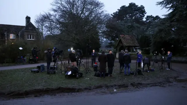 Media teams gather outside Sandringham with cameras and equipment