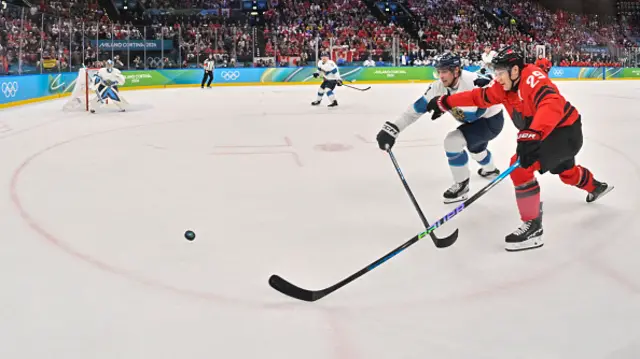 Canada's #29 Nathan Mackinnon (R) and Finland's #41 Miro Heiskanen vie for the puck