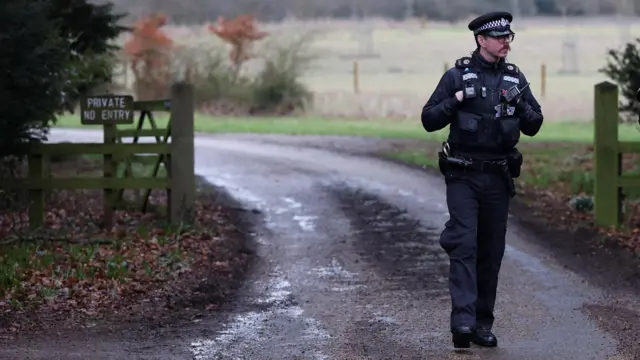 A police officer on a road near Wood Farm in Sandringham