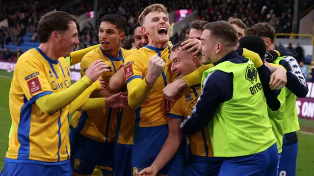 Louis Reed of Mansfield Town celebrates scoring his team's second goal with Will Evans and team-mates during the FA Cup Fourth Round win at Burnley