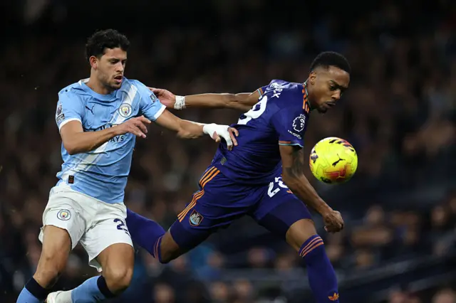 Manchester City's Portuguese midfielder #27 Matheus Nunes (L) vies with Newcastle United's English midfielder #28 Joe Willock