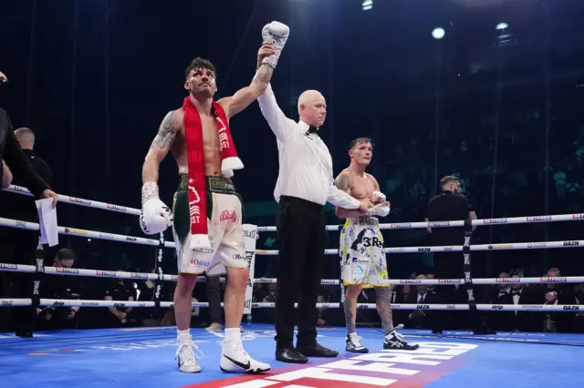 Josh Warrington claps as Leigh Wood's hand is raised