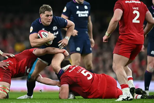 Duhan Van der Merwe carries the ball for Scotland