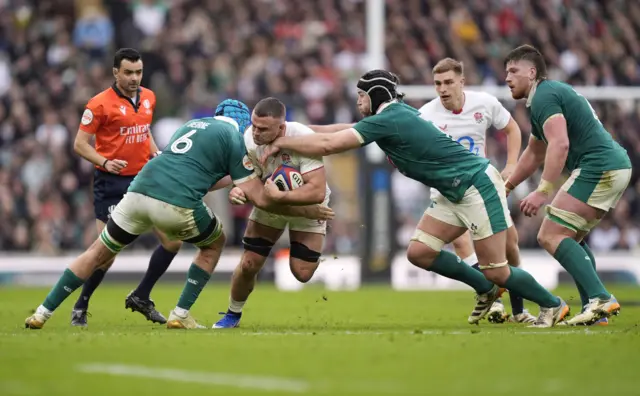 England's Ben Earl tackled by Ireland's Tadhg Beirne (left) and Caelan Doris