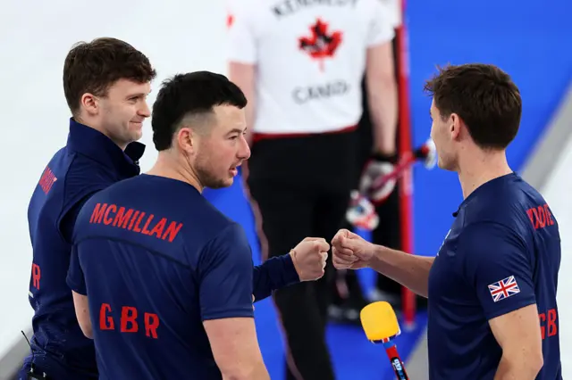 Bruce Mouat, Hammy McMillan and Grant Hardie of Team Great Britain interact