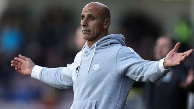 Barrow boss Dino Maamria pictured with his arms out