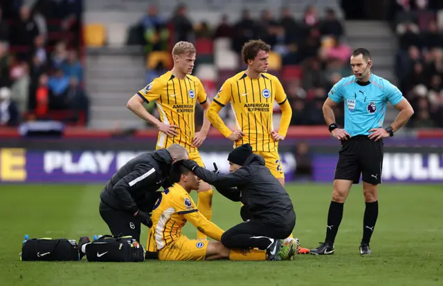 Diego Gomez of Brighton & Hove Albion receives medical treatment