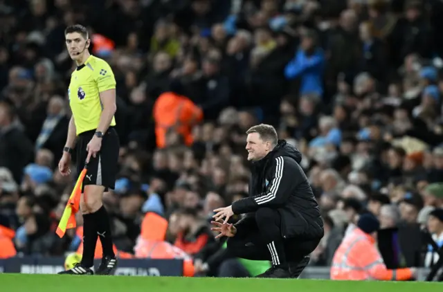 Howe crouches in his technical area
