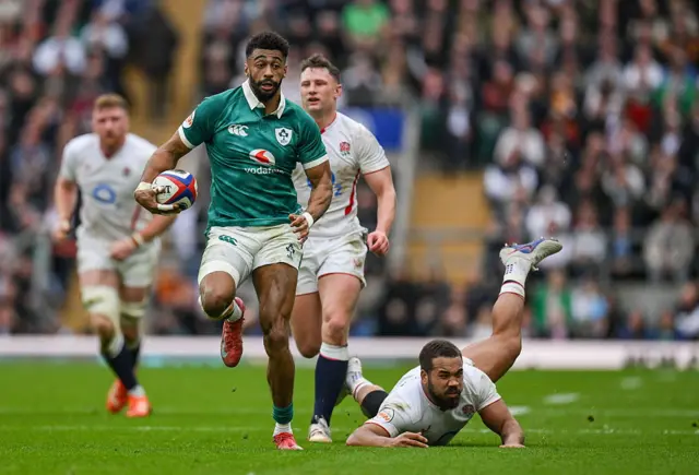 Robert Baloucoune of Ireland evades the tackle of England's Ollie Lawrence,