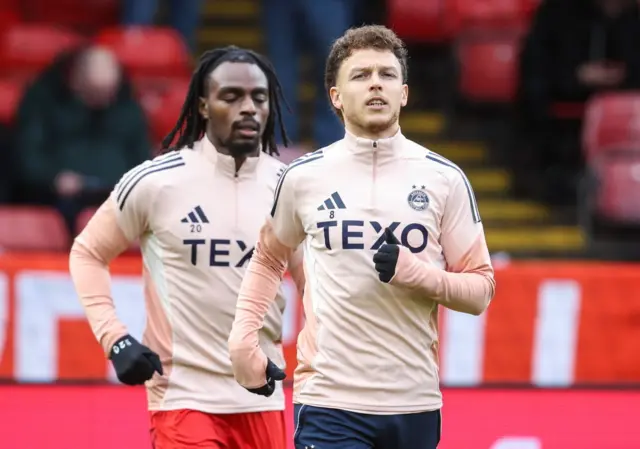 Dennis Geiger and Toyosi Olusanya warming up at Pittodrie