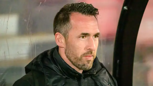 Newport boss Christian Fuchs in the dugout during the 3-1 win at Salford