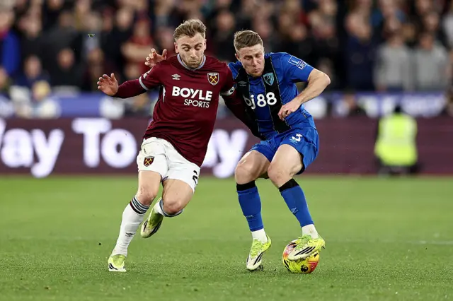 Adrien Truffert of AFC Bournemouth is challenged by Jarrod Bowen of West Ham United