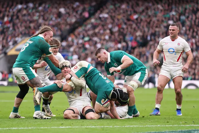 Caelan Doris of Ireland is tackled by Henry Pollock