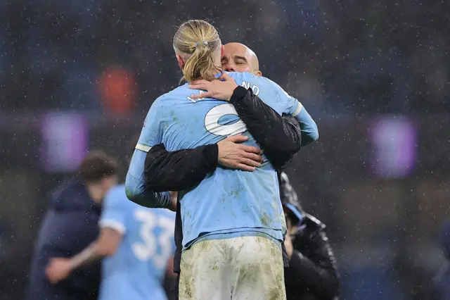 Josep 'Pep' Guardiola, head coach of Manchester City, embraces Erling Braut Haaland of Manchester City