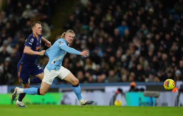 Burn pulls Haaland's shirt as he tries to run clear