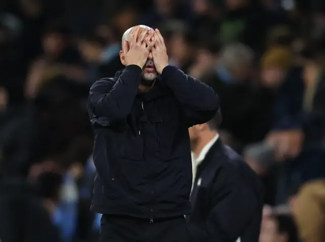Pep Guardiola reacts by putting his hands over his eyes