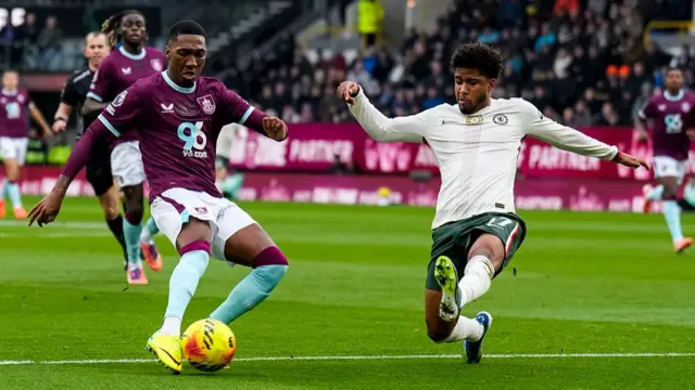 Jaidon Anthony of Burnley shoots while Andrey Santos of Chelsea slides to block
