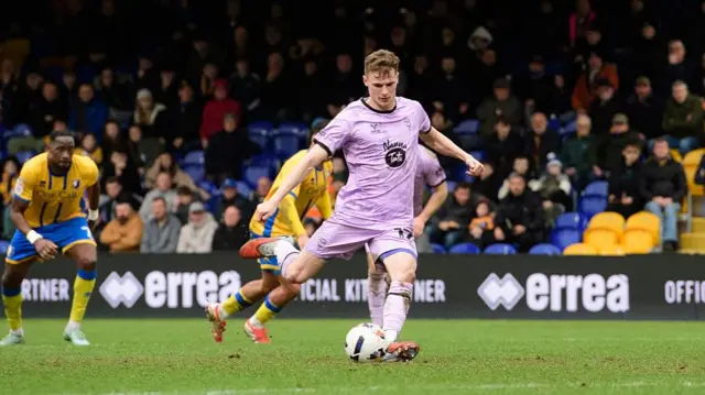 Rob Street stroking home a penalty for Lincoln at Mansfield