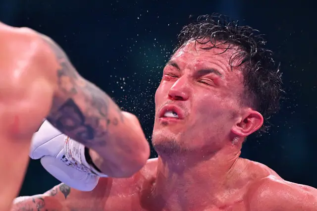 Josh Warrington has his eyes shut after being punched in the face