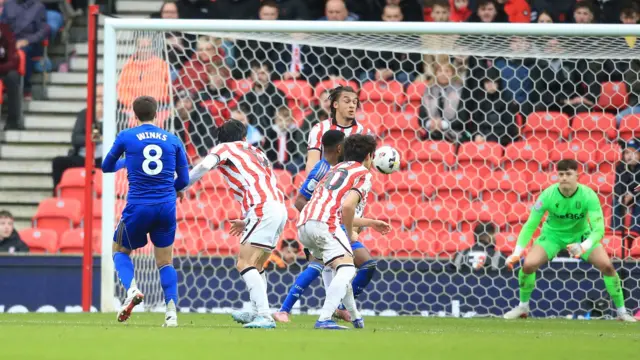 Harvey Winks (far left) watches as the ball floats through three Stoke players and flies towards the goal