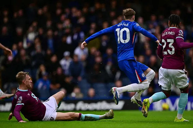 Burnley's English defender #04 Joe Worrall (L) makes a challenge on Chelsea's English midfielder #10 Cole Palmer (2R) which was looked at by the VAR