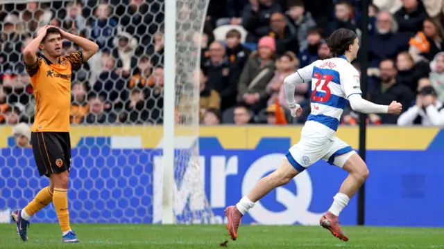 Daniel Bennie runs to the right away from goal after scoring while a Hull player holds his hands on the top of his head