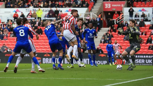 Ben Wilmot (centre) jumps in the air with four Leicester players around him in the box