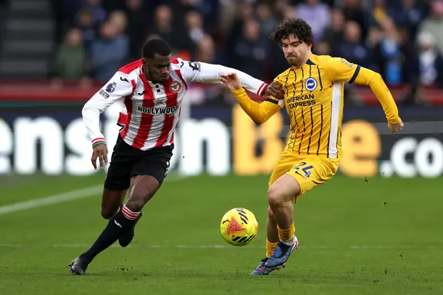Dango Ouattara of Brentford runs with the ball