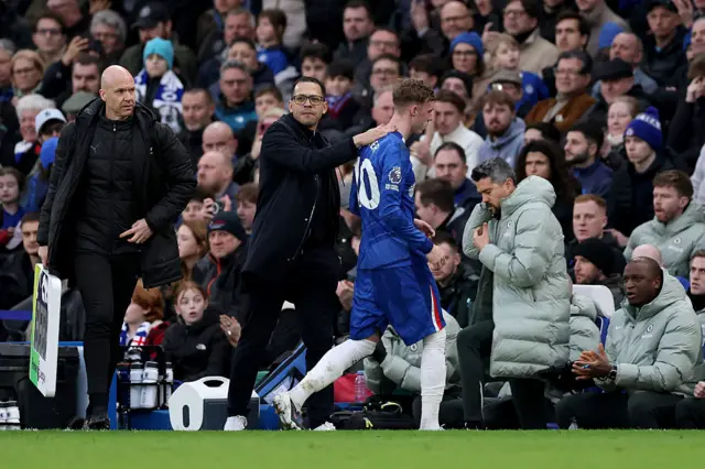 Liam Rosenior, Manager of Chelsea, interacts with Cole Palmer