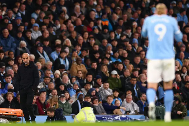 Guardiola watches on with Haaland in his eyeline