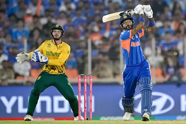 India's Hardik Pandya (R) plays a shot as South Africa's wicketkeeper Quinton de Kock reacts
