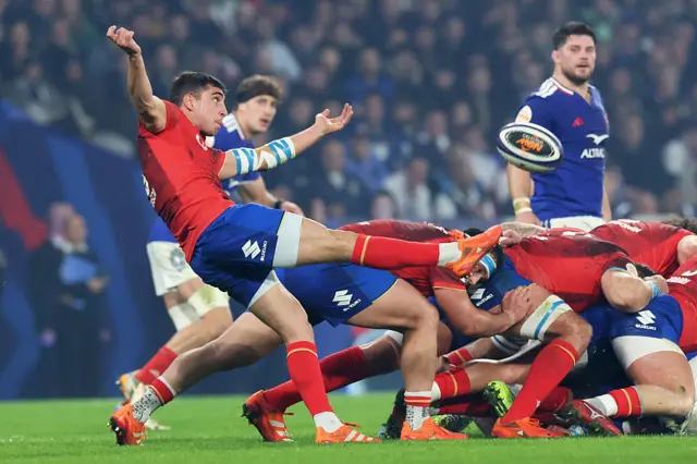 Alessandro Fusco of Italy kicks the ball from behind a ruck