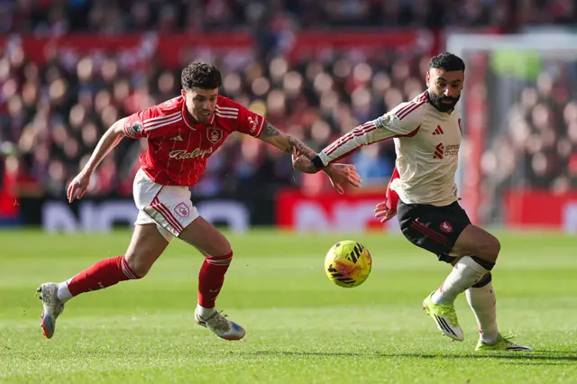 Mohamed Salah of Liverpool is challenged by Neco Williams of Nottingham Forest