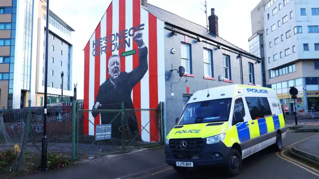 Police van outside Chris Wilder mural
